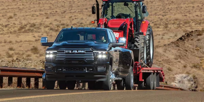 2026 RAM 3500 towing a tractor